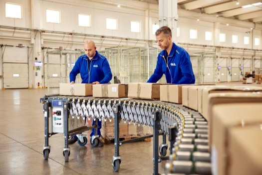 Two employees working on a conveyor belt